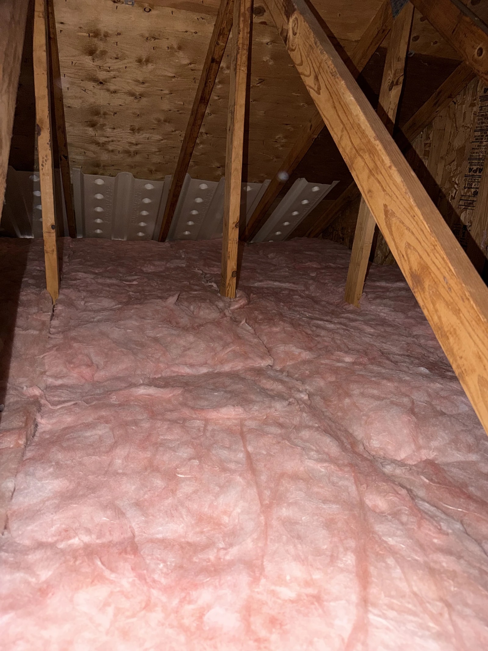 Fresh insulation and rafter baffles after an attic cleanout
