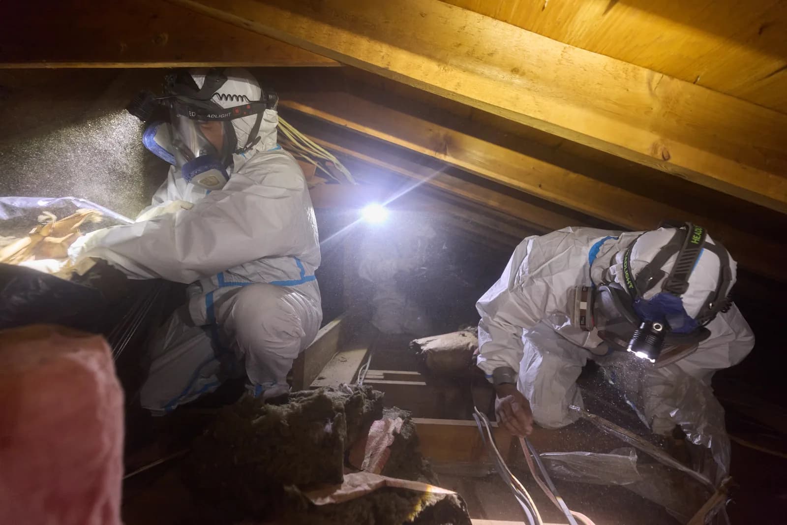 Attic Fanatics crew working together in an attic during an insulation job