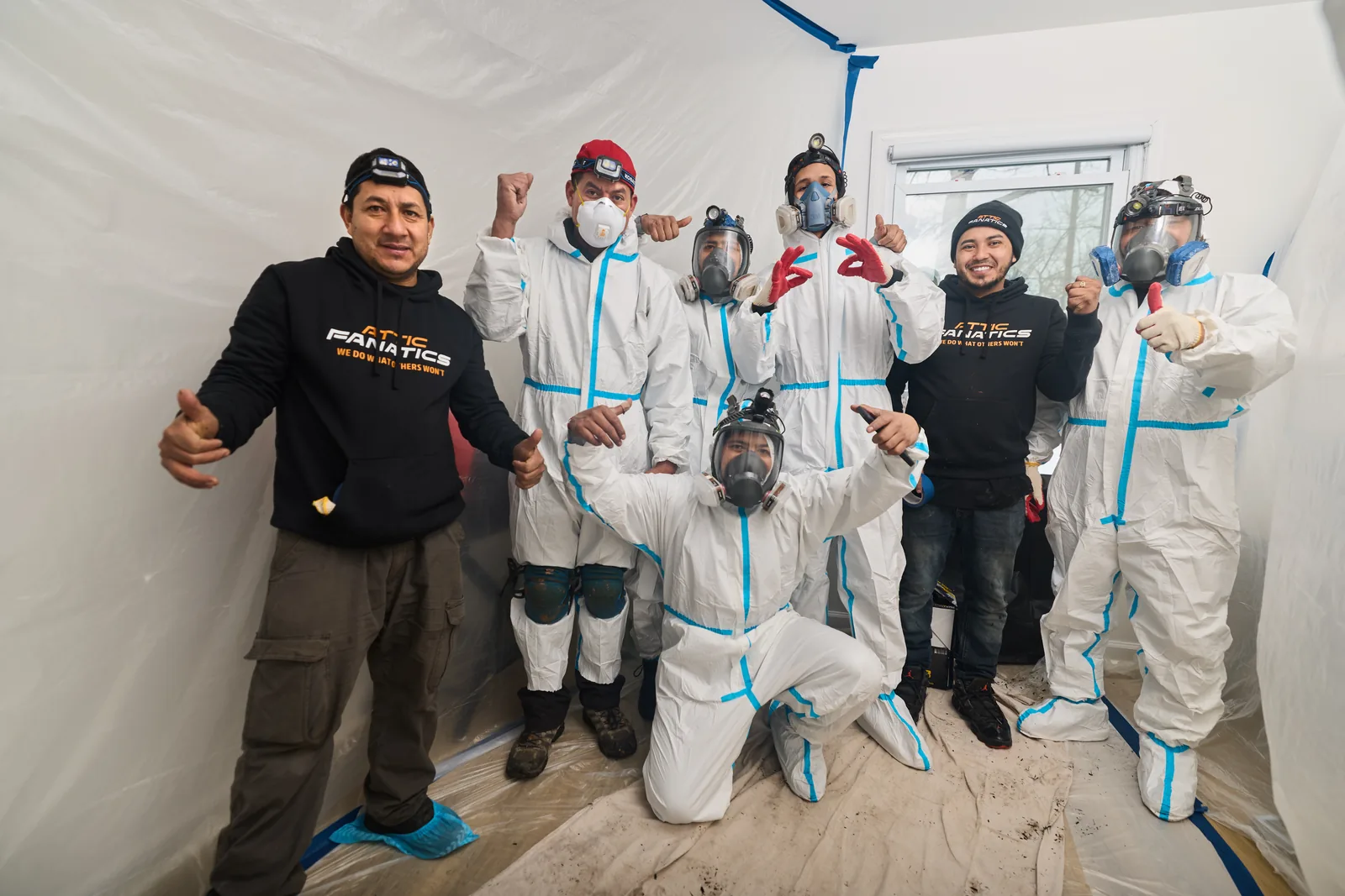 Attic Fanatics crew in hazmat gear ready for attic restoration
