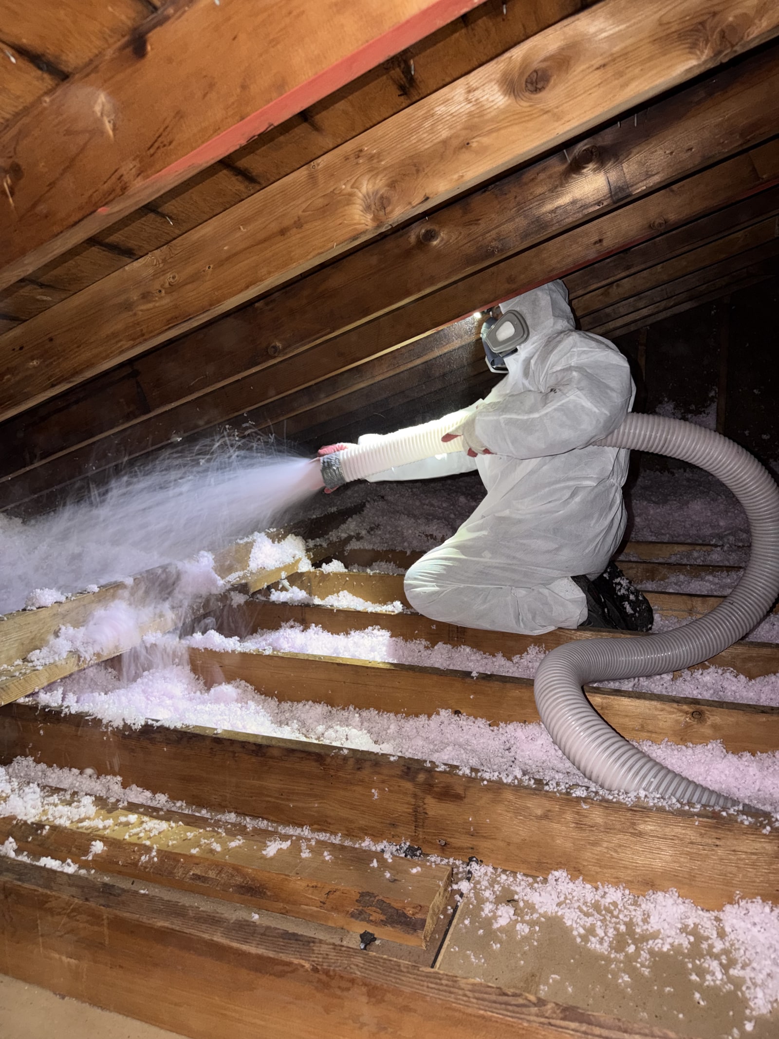 Blown-in insulation being installed in a New Jersey attic