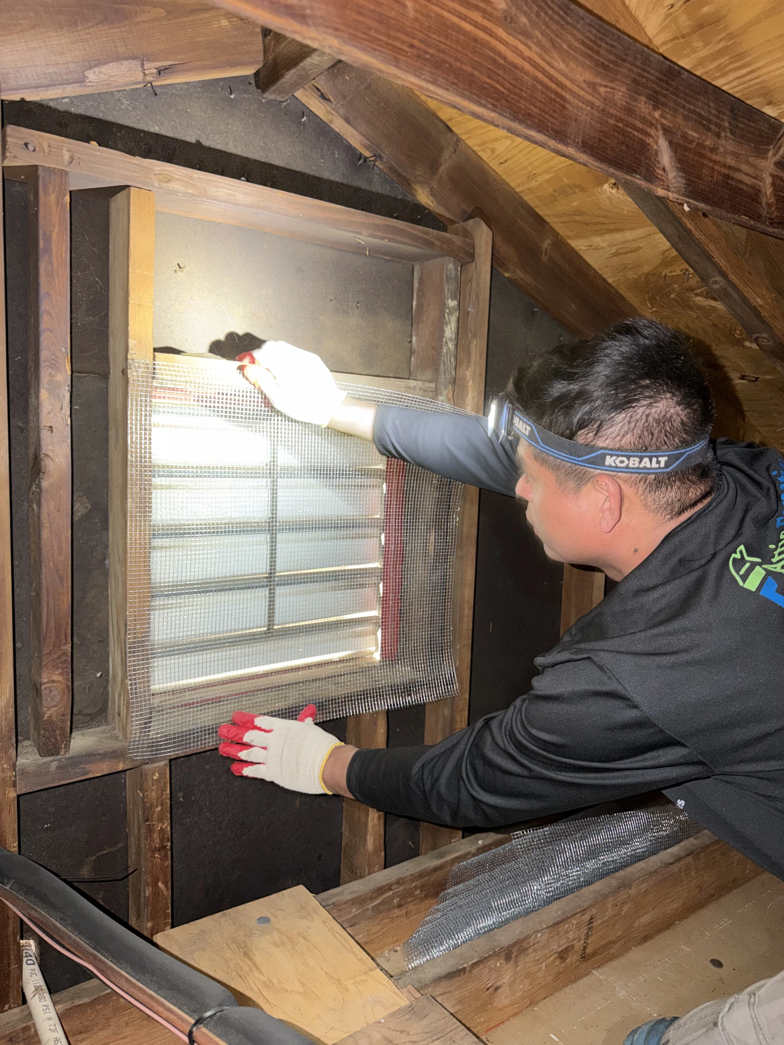 Attic Fanatics crew sealing rodent entry points on a home exterior